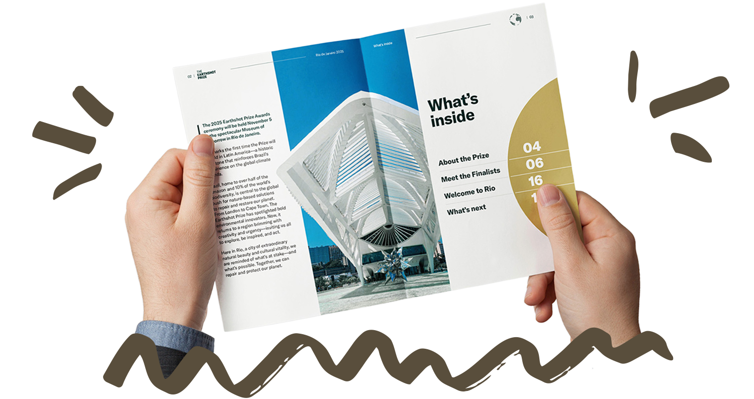 A mockup of someone holding the inside spread to the Earthshot Prize guide, with a large photo of the Museum of Tomorrow.